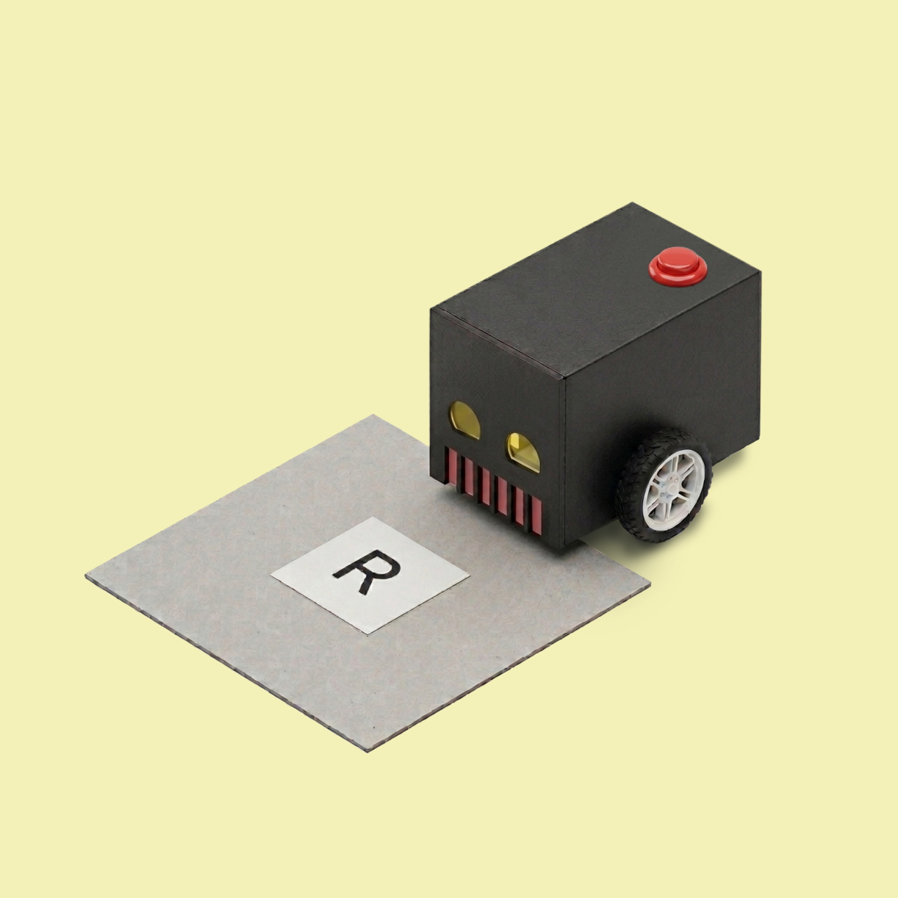 Two-wheeled robot in black that is about to drive over a square floor plate with the letter 'R'.